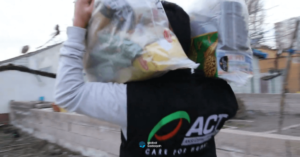 One of the crew members from ACT carrying food pack to be distributed to the beneficiaries. 