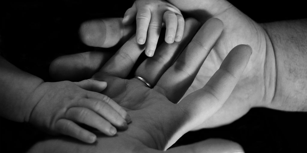 babys hand on human palm